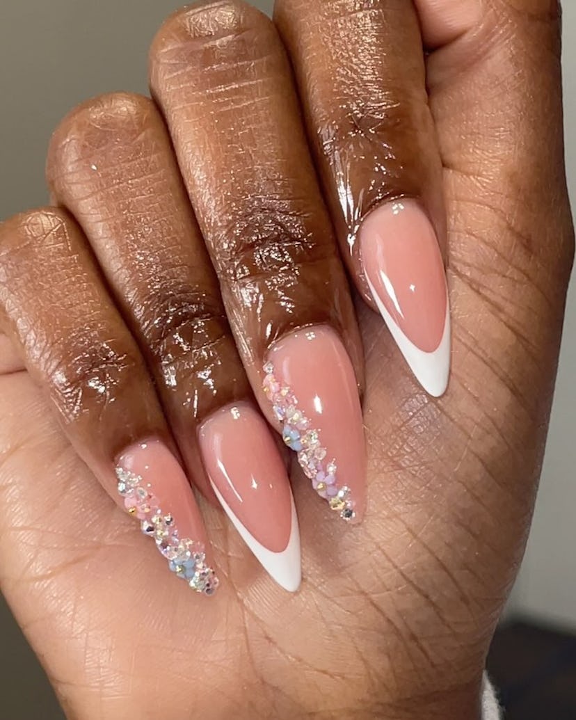 Bedazzled French tip nails are on-trend for summer 2024.