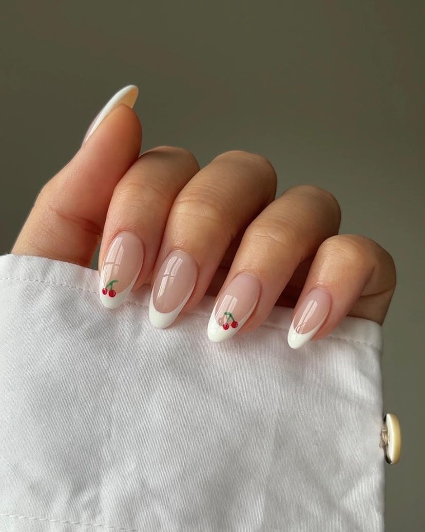 French tip nails with micro cherry details are on-trend for summer 2024.