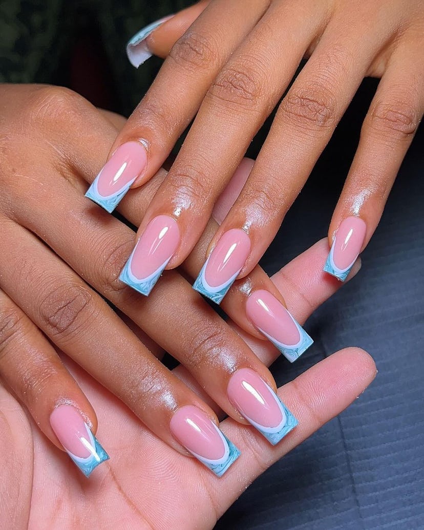 Baby blue swirled French tip nails are on-trend for summer 2024.