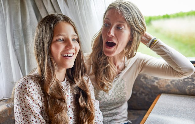 A surprised mother sits with her tween daughter.