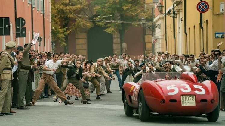 A red car drives down a crowded Italian street in 'Ferrari'