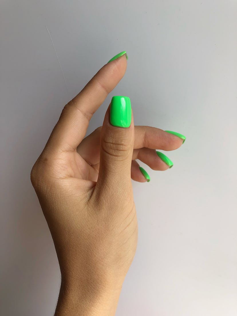 Summer nail trends include square and squoval nails, like this neon green manicure.