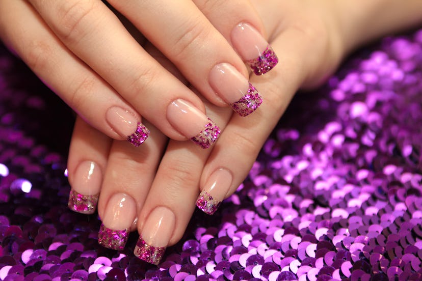 Pink glitter french manicure, in a story about 2024 summer nail trends.