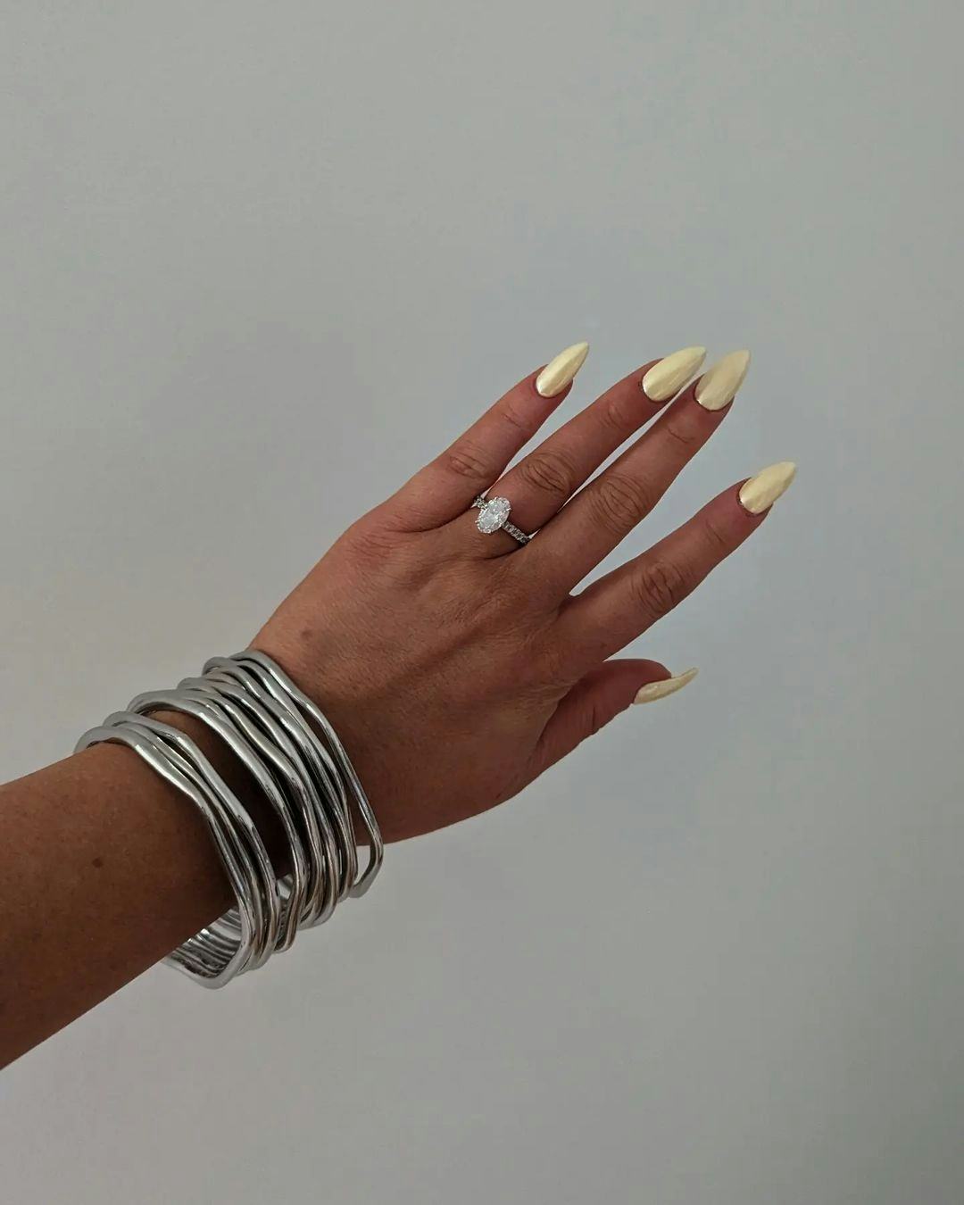 Butter yellow chrome nails are trending for summer 2024.