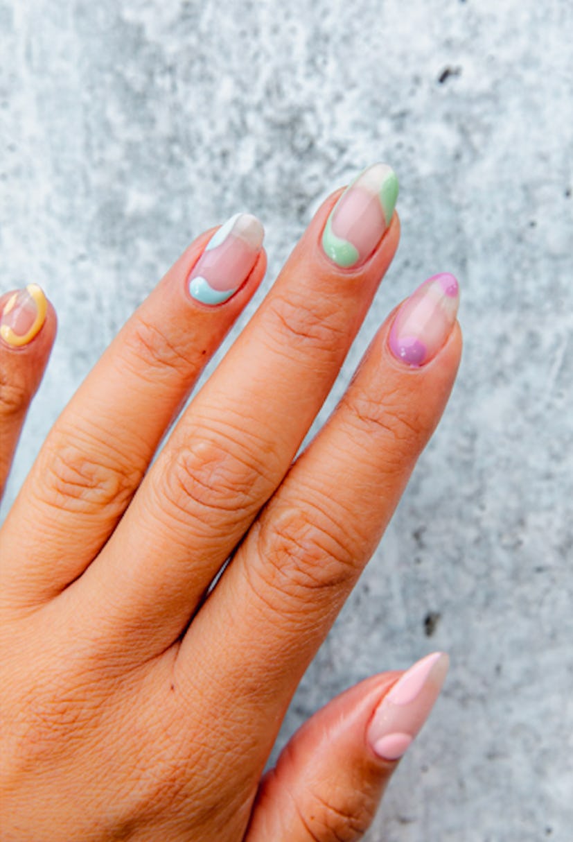 2024 summer nail trends include negative space manicures, like this one with pastel abstract shapes ...