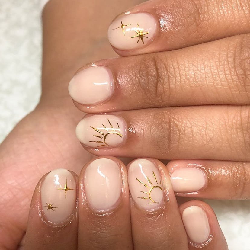 Try simple nails with gilded celestial art.