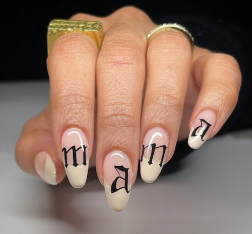 Mother's Day nails with french tips and script font that reads "mama"