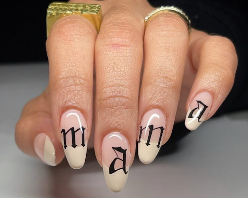 Mother's Day nails with french tips and script font that reads "mama"