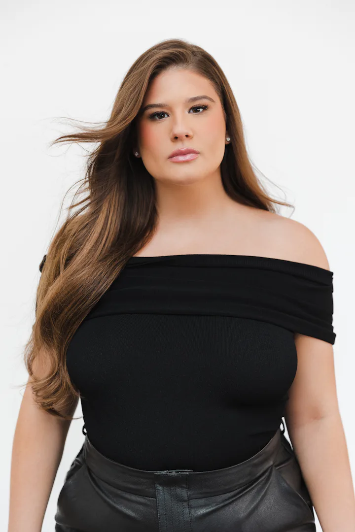 Remi Bader photographed on a white background looking straight to camera.