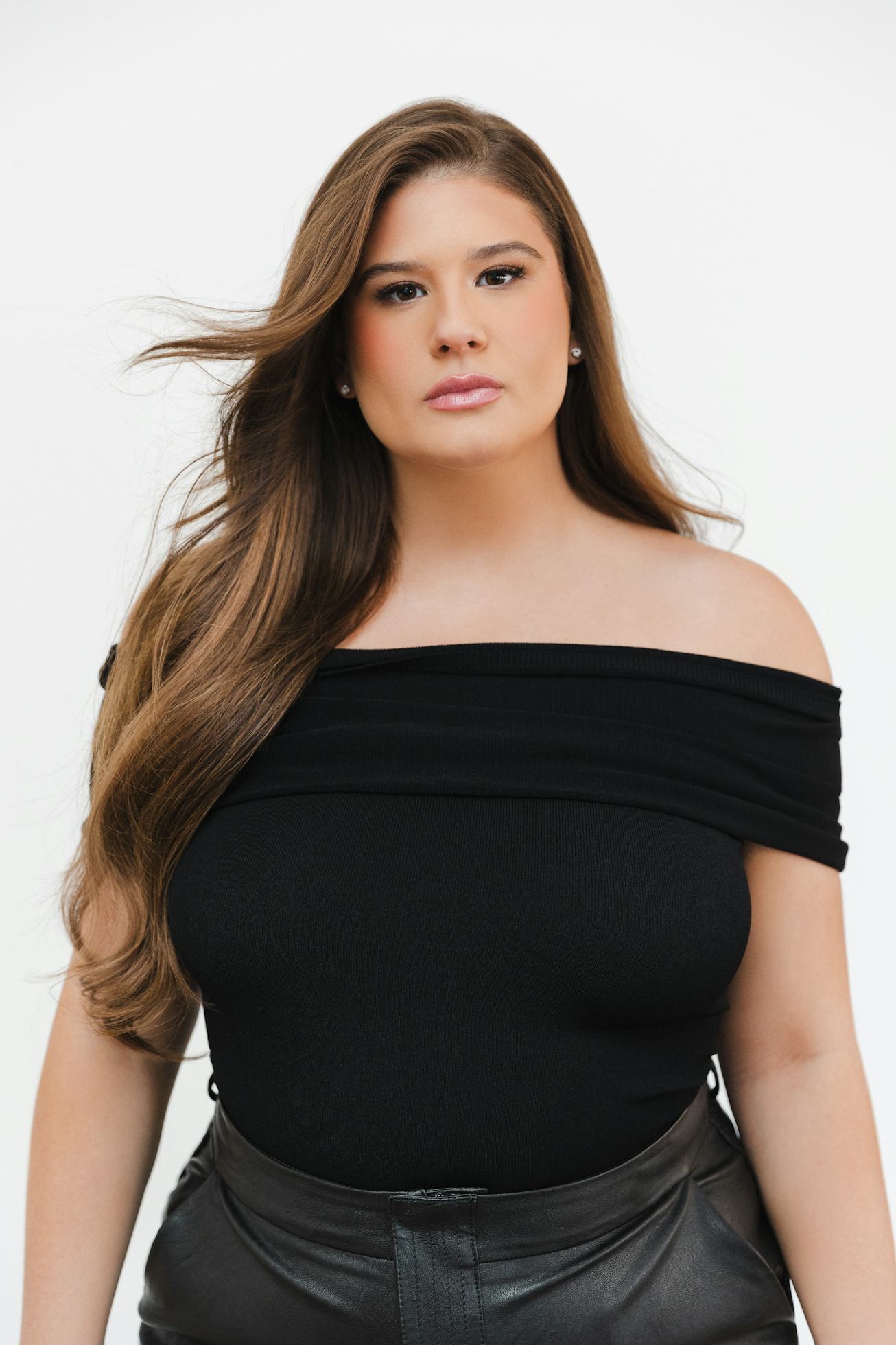 Remi Bader photographed on a white background looking straight to camera.