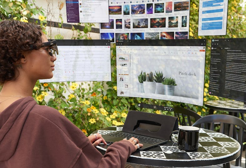 A person using a Spacetop in a garden with their windows arranged around them.