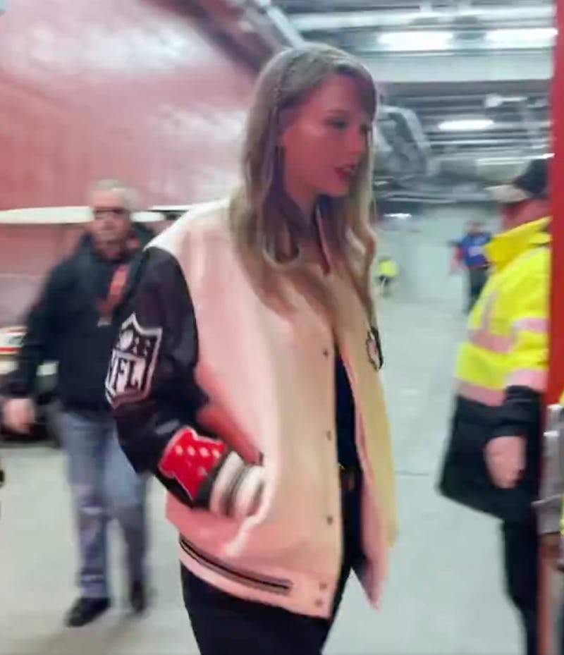 Taylor Swift wearing Travis Kelce's Chiefs jacket.