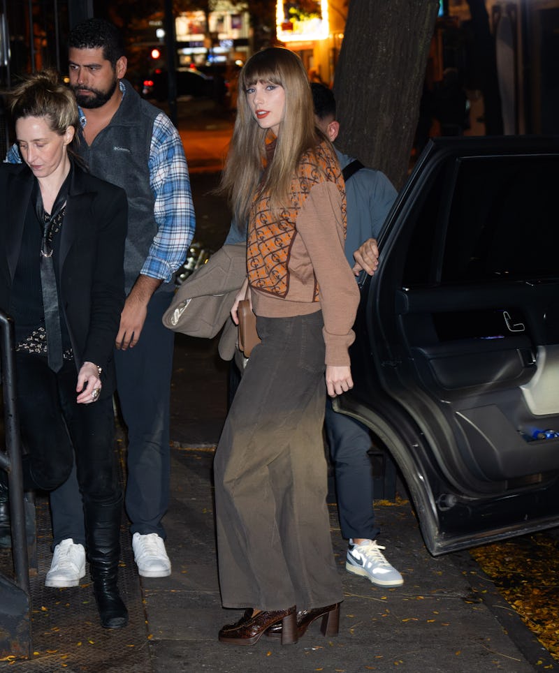 Taylor Swift wearing a brown sweater out to dinner in November 2023.