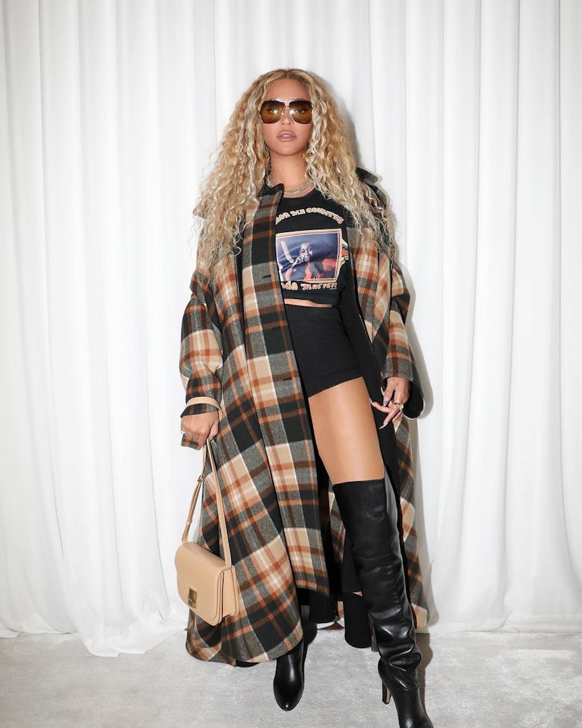 Beyoncé wears a tee, knit micro shorts, and boots.