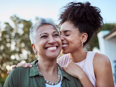 A mother and daughter embrace.