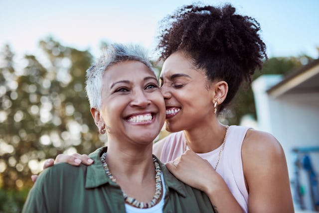 A mother and daughter embrace.