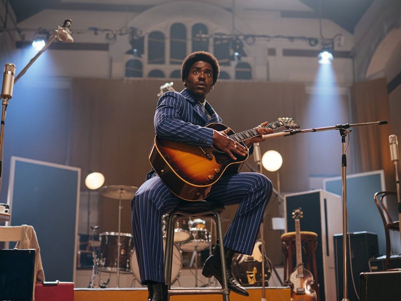 Ncuti Gatwa, holding a guitar, playing the Doctor in "The Devil's Chord," an episode of 'Doctor Who'...