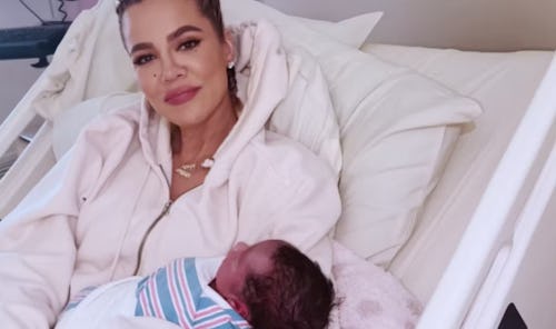 Khloe Kardashian holding her newborn son Tatum. 