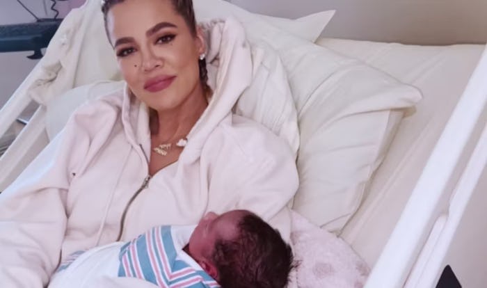 Khloe Kardashian holding her newborn son Tatum.