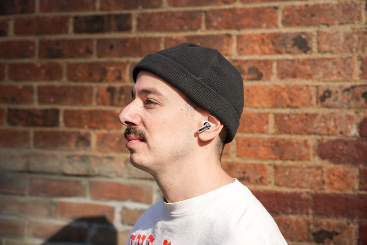 Man wearing Ear wireless earbuds.