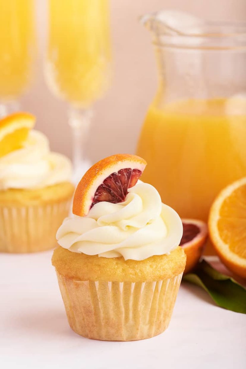 Mimosa cupcakes topped with orange, a delicious make-ahead dessert for Mother's Day.