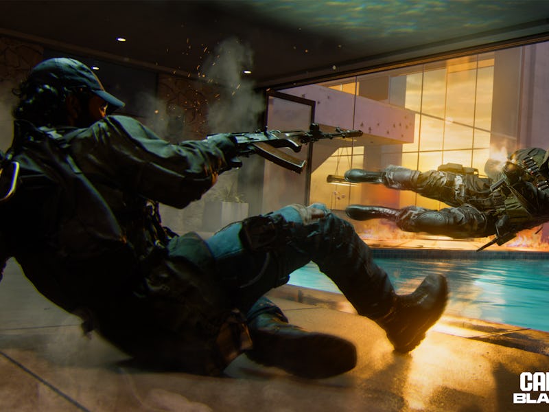 Two soldiers in futuristic gear slide on a wet floor, firing weapons, with an explosive backdrop, fr...