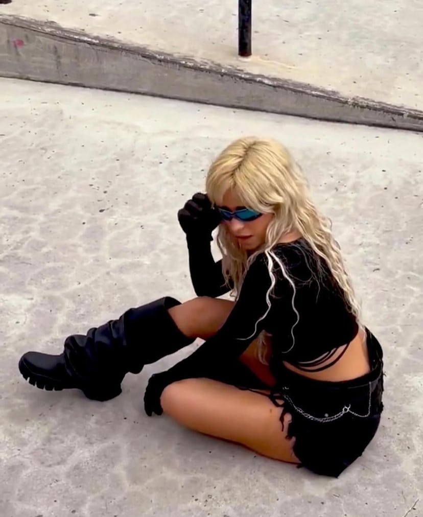 Camila Cabello on Instagram wearing denim cutoff shorts with a Y2K belt chain.