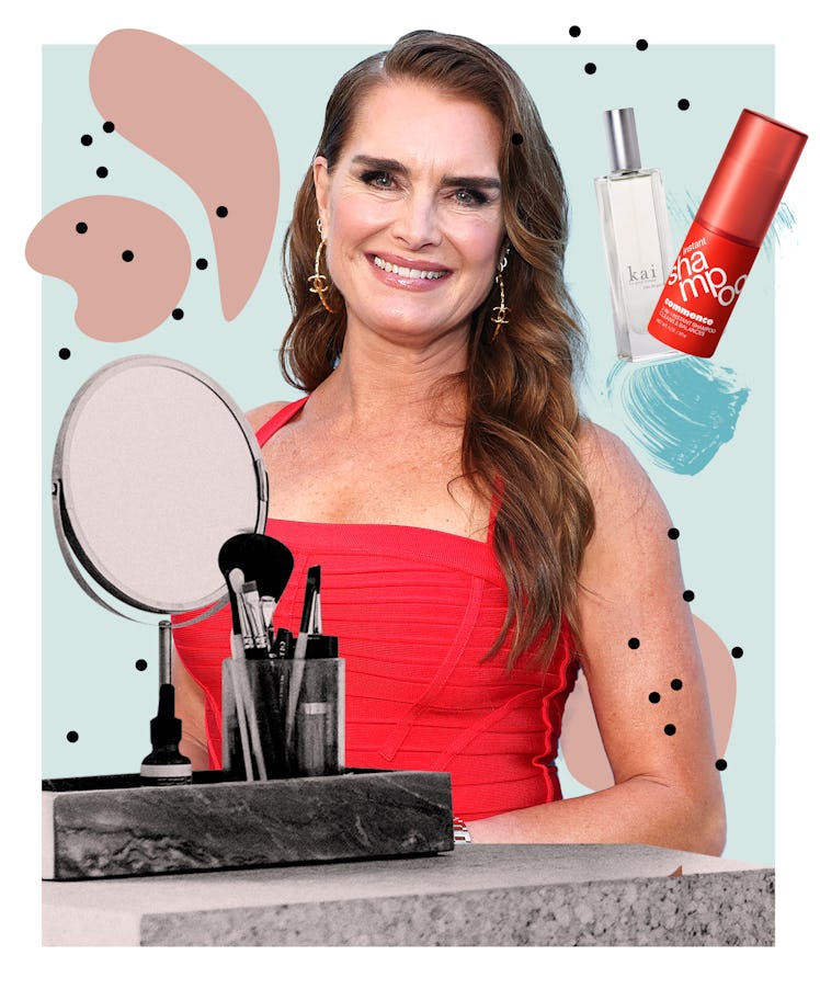Woman in red dress with makeup products, a mirror, and skincare bottles on an abstract background.