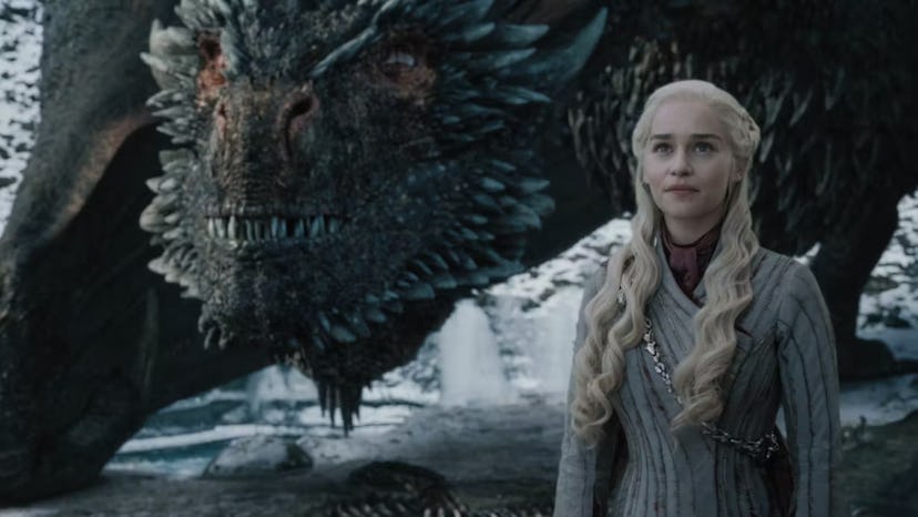 Daenerys Targaryen standing with her dragon in Game of Thrones