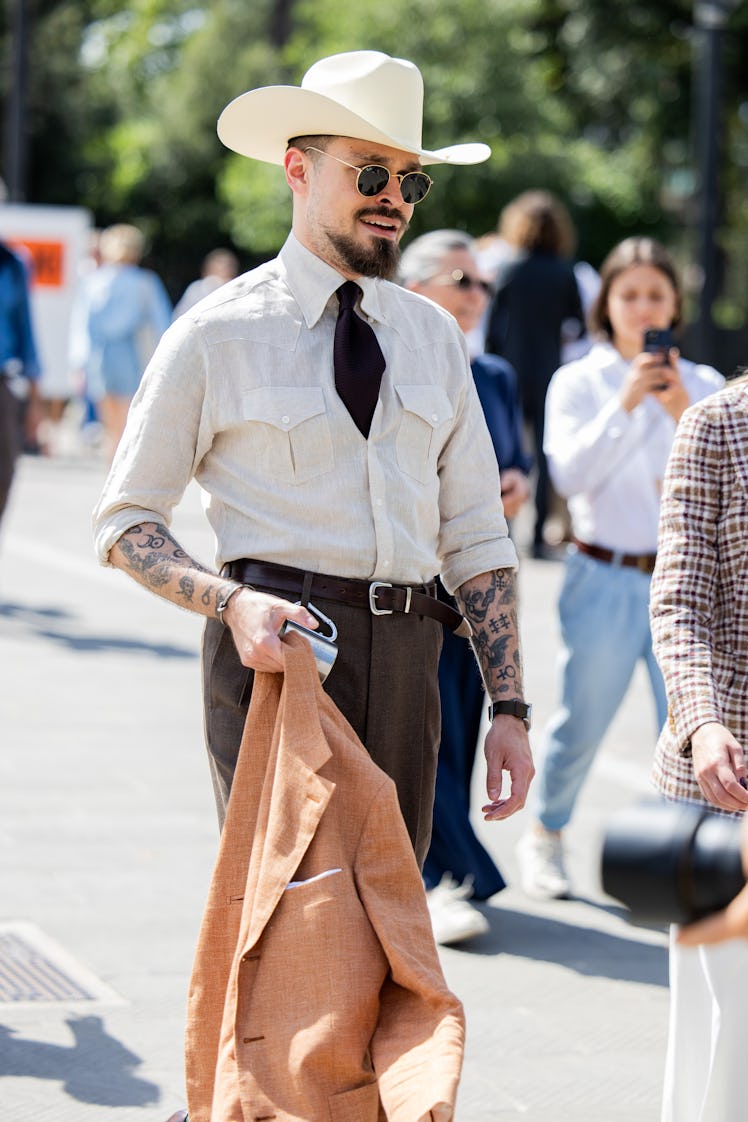 A guest wears cowboy hat during Pitti Immagine Uomo 106 on June 12, 2024 in Florence, Italy.