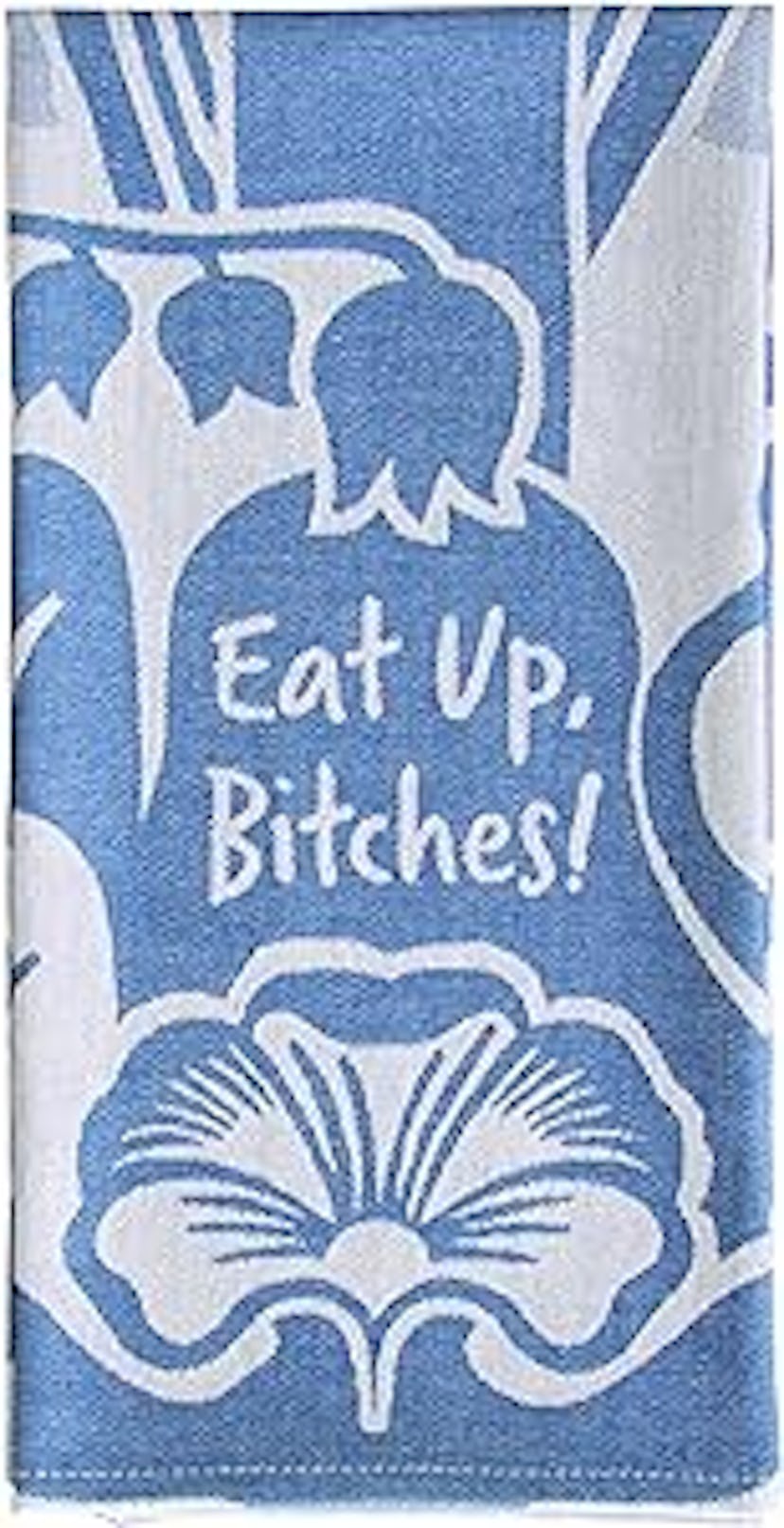 Blue and white floral towel with the humorous phrase "Eat Up. Bitches!" written in a casual font.