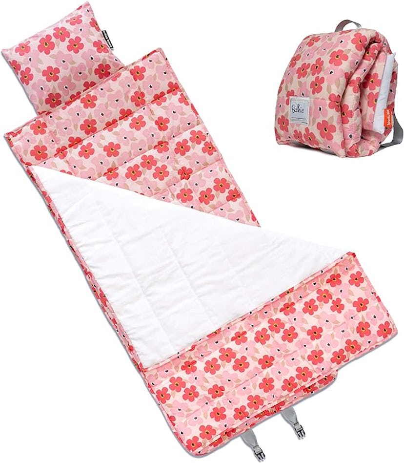 Pink floral-printed nap mat with attached pillow and blanket, displayed next to a matching backpack.