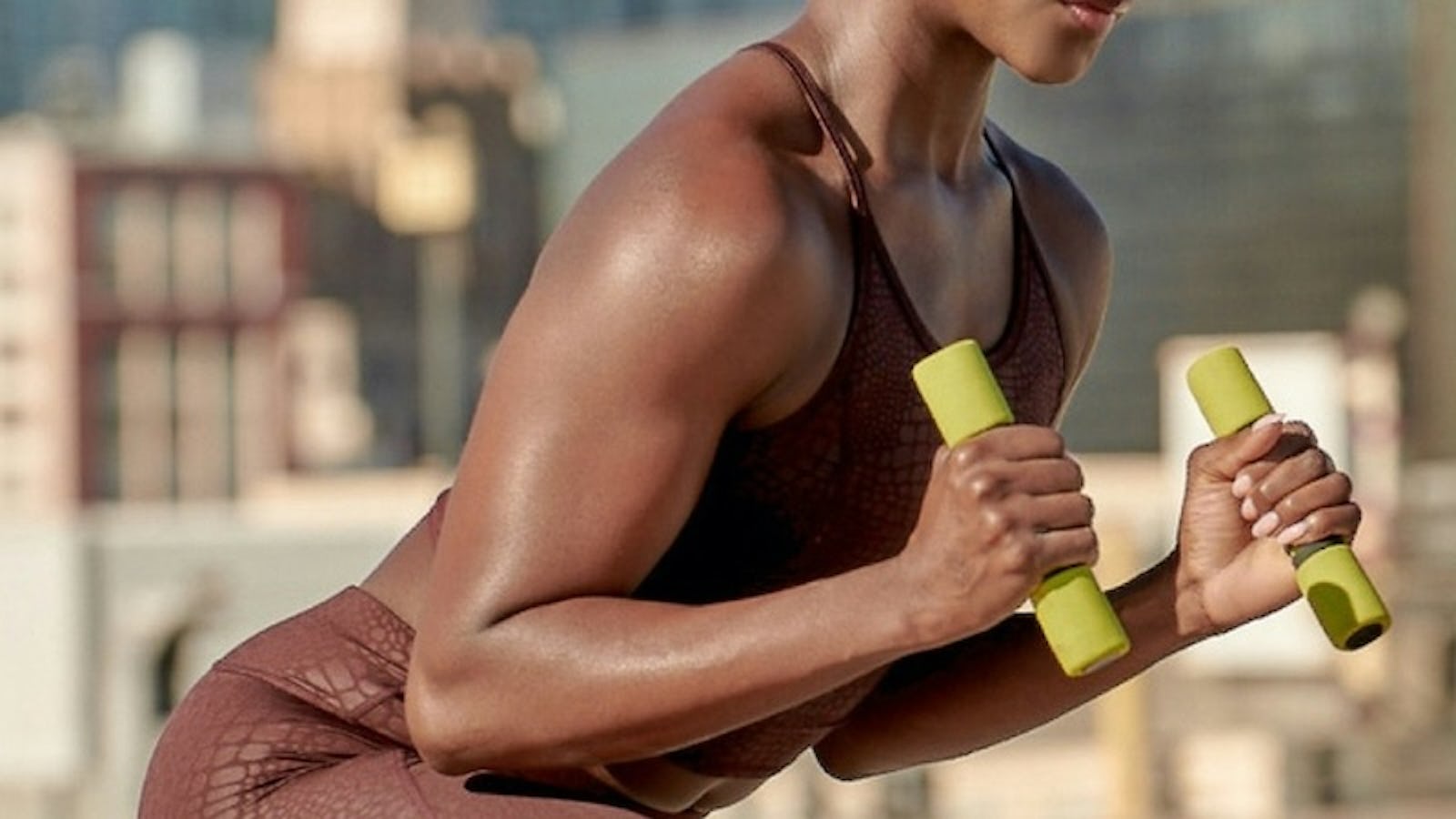 black woman working out in brown exercise set