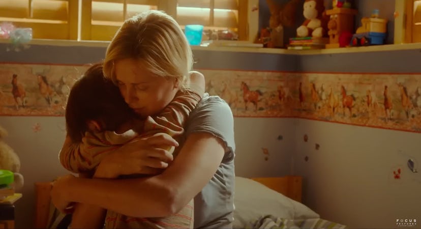 Marlo hugs her older child in their bedroom.