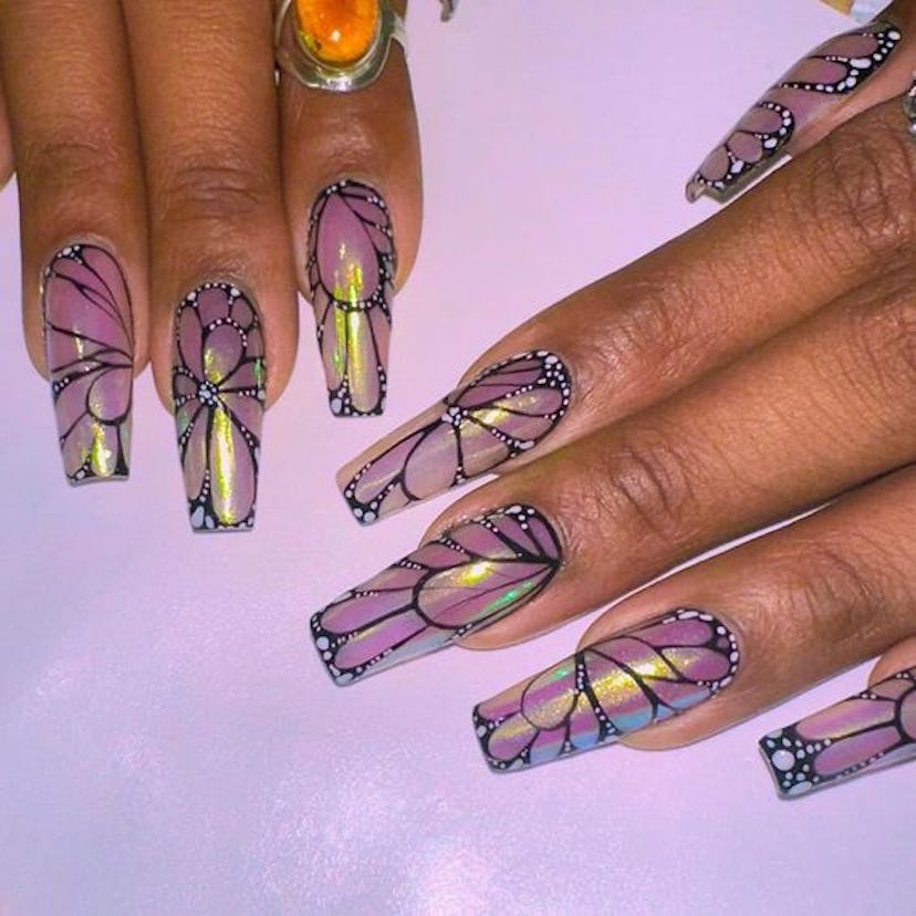 Megan Thee Stallion shared a snap of her purple butterfly wing manicure.