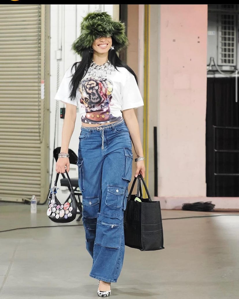 WNBA star Isabell Harrison wore a pair of cargo jeans with a graphic t-shirt.