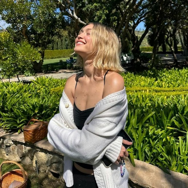 Gigi Hadid outdoors wearing summer outfit with short bob