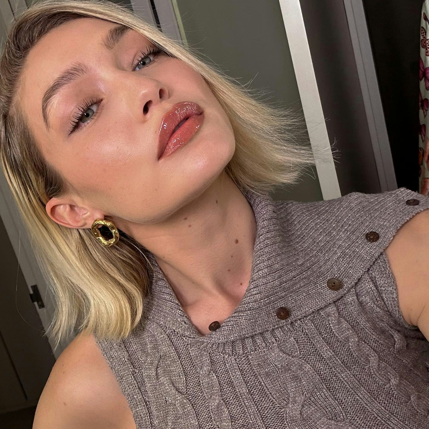 Model Gigi Hadid takes a selfie for Instagram, showing off her light pink makeup look.