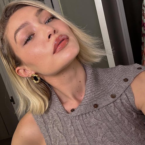 Model Gigi Hadid takes a selfie for Instagram, showing off her light pink makeup look.