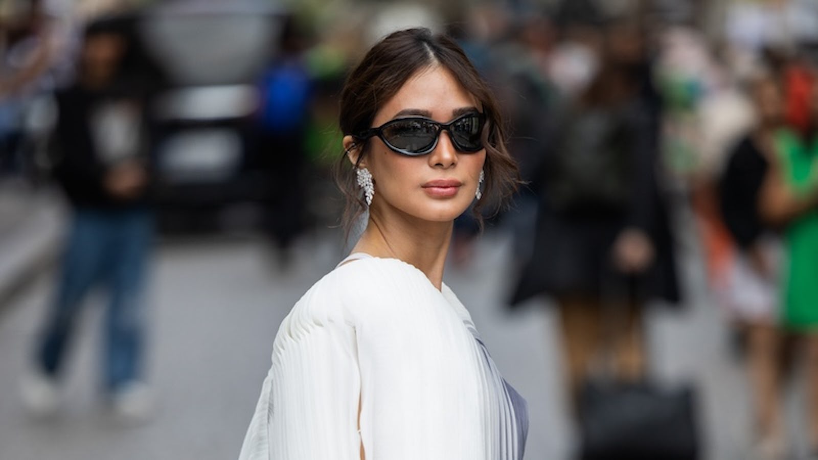 PARIS, FRANCE - JUNE 20: Heart Evangelista wears silver Fendi bag, cropped blouse, denim jeans, sunglasses outside Bluemarble during the Menswear Spring/Summer 2025 as part of Paris Fashion Week on June 20, 2024 in Paris, France. (Photo by Christian Vierig/Getty Images)