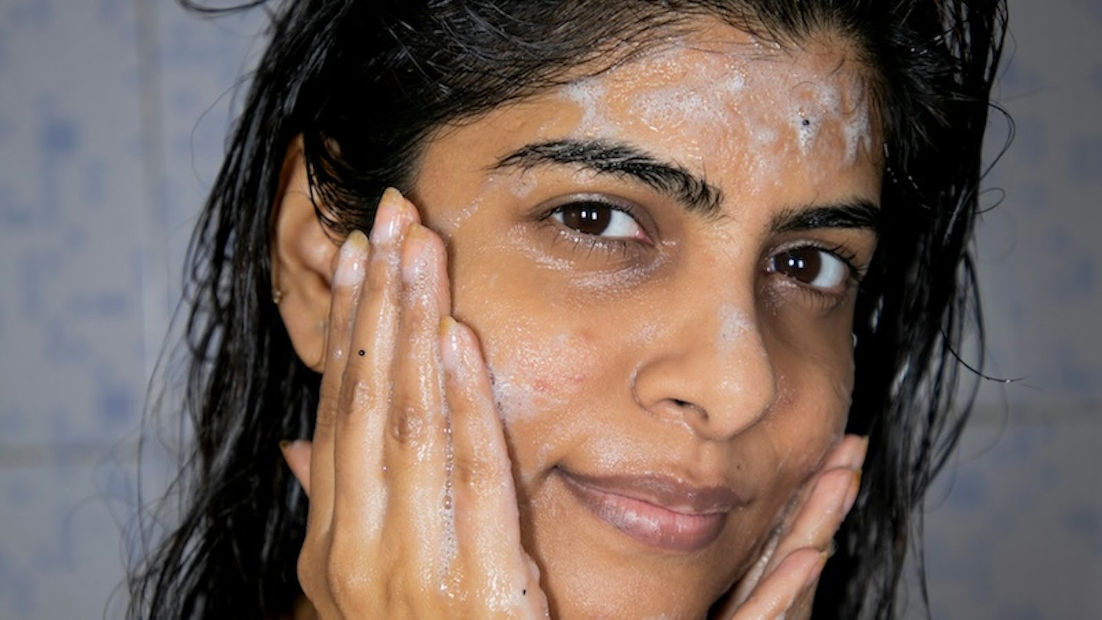 south asian model washes her face