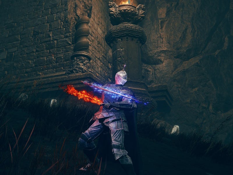 A knight with glowing blue armor stands near a stone pillar, holding a flaming blue and orange sword...