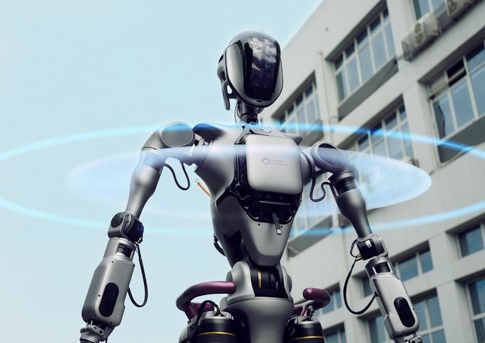 A futuristic robot with a sleek design and blue holographic wings, set against a modern building background.