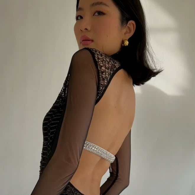 model wears backless lace dress with crystal embellished BAXXE bra