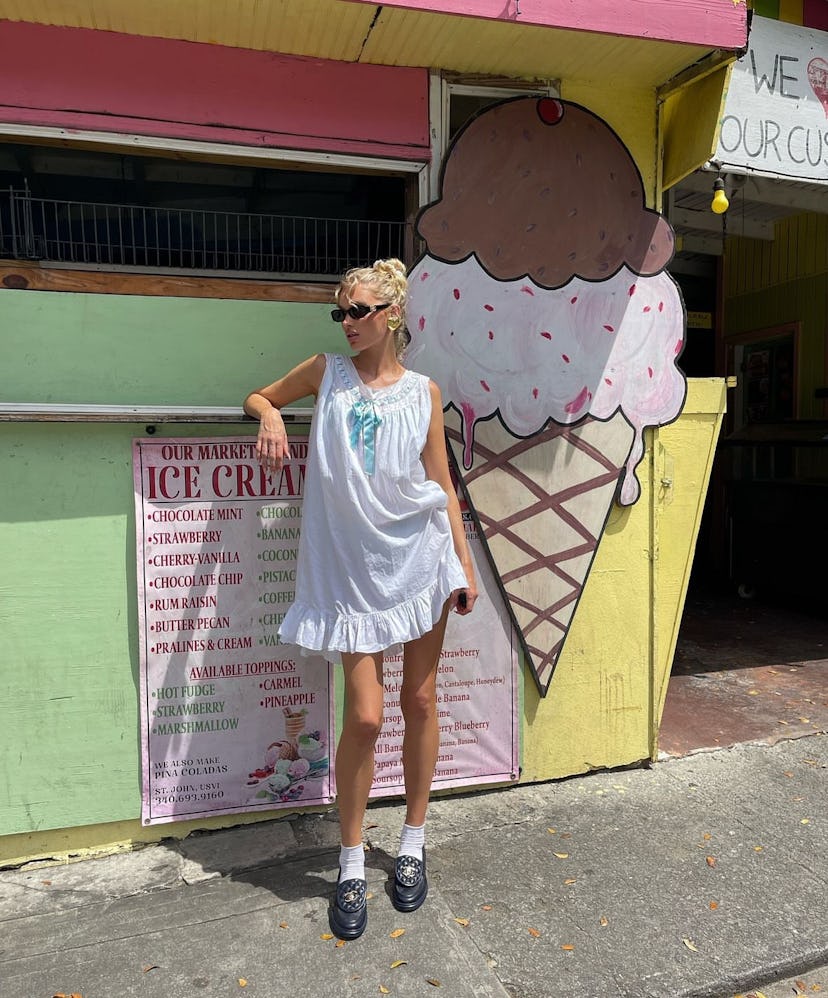Model Elsa Hosk wears a vintage night gown as a bikini coverup while on a beach vacation.