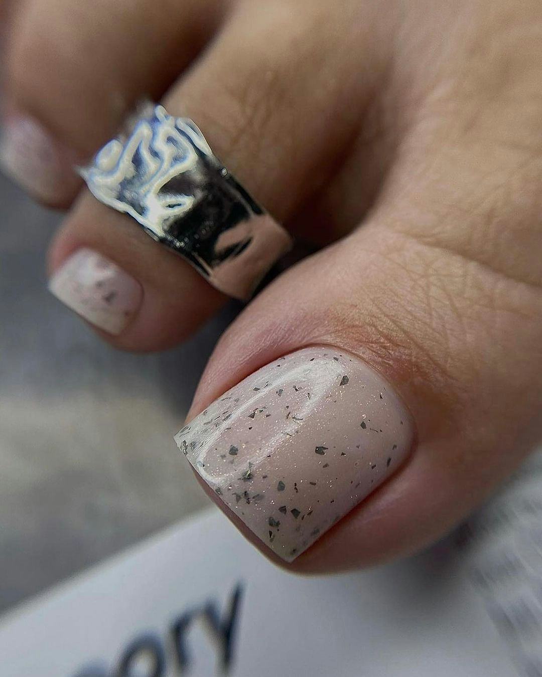 Neutral polish with silver flecks are perfect for Cancer season 2024.