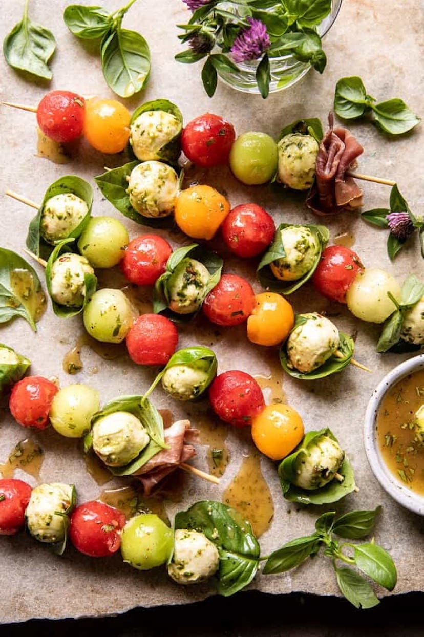 One make-ahead Fourth of July appetizer to make is marinated mozzarella melon skewers.