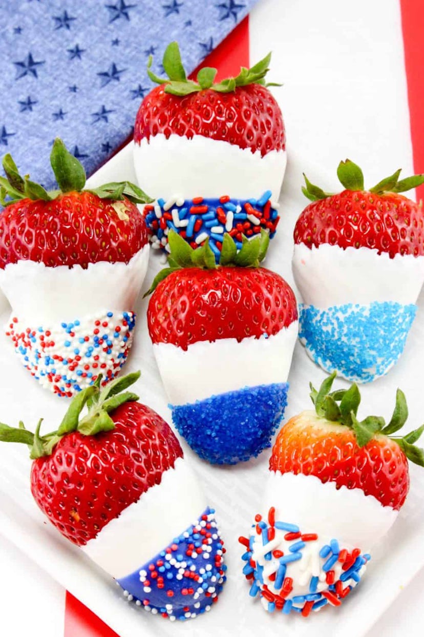 Red, white, and blue chocolate covered strawberries is a make-ahead Fourth of July dessert idea to e...