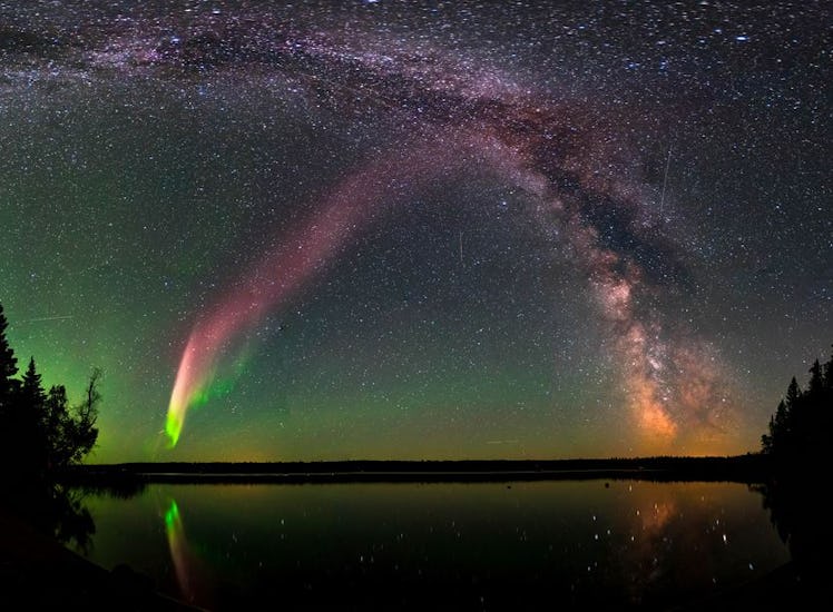 photo of aurora and a spiral arm of the Milky Way in the night sky.