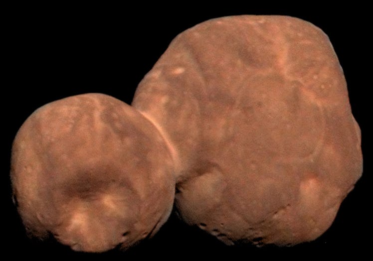 photo of a reddish-brown pair of rocks in space, stuck together.